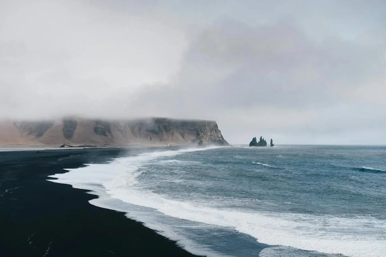 Dramatic coastline with black sand beach